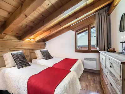 two beds in a room with wooden ceilings at Duplex 3 Chambres à Megève - Confort et Wifi - FR-1-453-49 in Megève