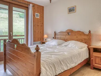 a bedroom with a large bed and a window at Appartement cosy avec mezzanine, parking, 4 pers., proche télécabine à Megève - FR-1-453-51 in Megève