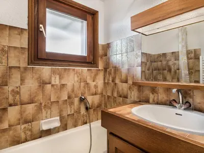 a bathroom with a sink and a tub and a mirror at Appartement cosy avec mezzanine, parking, 4 pers., proche télécabine à Megève - FR-1-453-51 in Megève