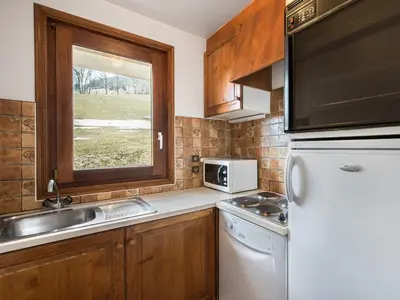 a kitchen with a white refrigerator and a sink at Appartement cosy avec mezzanine, parking, 4 pers., proche télécabine à Megève - FR-1-453-51 in Megève
