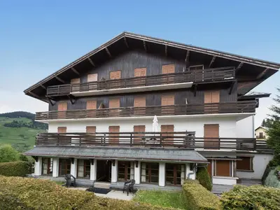 a large wooden building with a gambrel roof at Appartement cosy 2 chambres, terrasse et parking à Megève - FR-1-453-52 in Megève