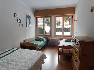 a bedroom with two beds and a window at Appartement cosy 2 chambres, terrasse et parking à Megève - FR-1-453-52 in Megève