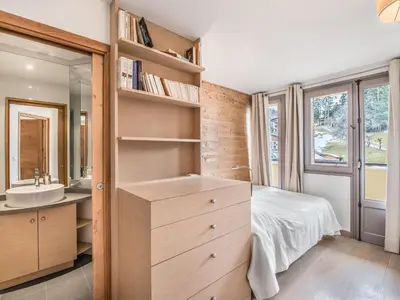 a bedroom with a bed and a sink and a mirror at Appartement central 2 chambres avec balcon et Wifi à Megève - FR-1-453-53 in Megève