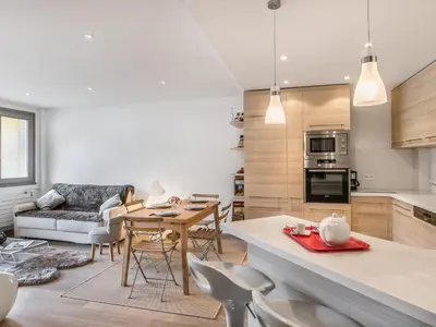 a kitchen and living room with a table and chairs at Appartement central 2 chambres avec balcon et Wifi à Megève - FR-1-453-53 in Megève