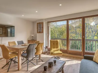 a living room with a table and chairs at Appartement 2 pièces à Megève, balcon au sud, proche centre - FR-1-453-54 in Megève