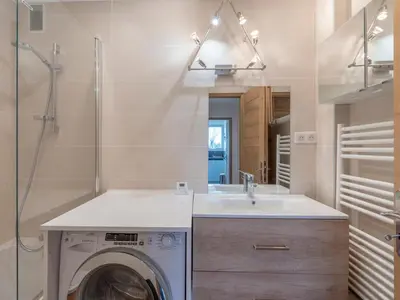 a bathroom with a washing machine and a sink at Appartement 2 pièces à Megève, balcon au sud, proche centre - FR-1-453-54 in Megève