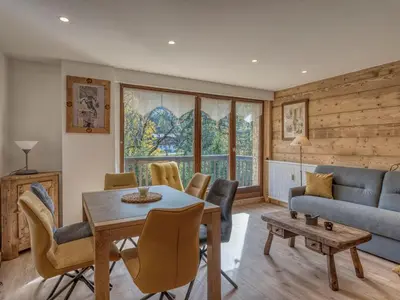 a living room with a table and chairs and a couch at Appartement 2 pièces à Megève, balcon au sud, proche centre - FR-1-453-54 in Megève