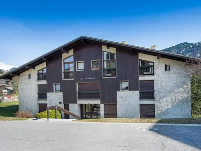 a largeartment building with a lot of windows at Appartement 2 pièces à Megève, balcon au sud, proche centre - FR-1-453-54 in Megève