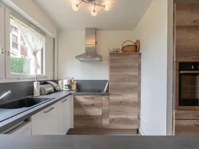 a kitchen with white cabinets and a sink and a window at Appartement 2 pièces à Megève, balcon au sud, proche centre - FR-1-453-54 in Megève