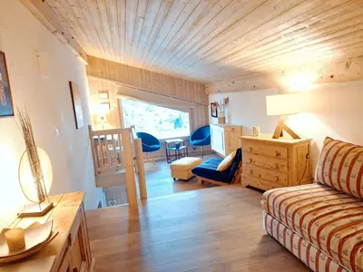 a living room with a wooden ceiling and a table at Appartement 1 chambre et mezzanine à Megève avec balcon et animaux admis - FR-1-453-57 in Megève