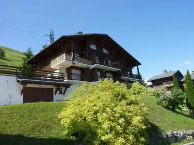 a large building on top of a hill at Appartement 1 chambre et mezzanine à Megève avec balcon et animaux admis - FR-1-453-57 in Megève
