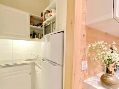 a kitchen with white cabinets and a refrigerator at Appartement 1 chambre et mezzanine à Megève avec balcon et animaux admis - FR-1-453-57 in Megève