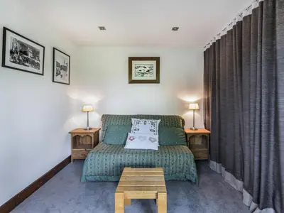 a living room with a couch and a table at Studio skis aux pieds à Megève, animaux permis - FR-1-453-58 in Megève