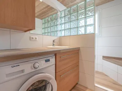 a laundry room with a washing machine and a sink at Appartement cosy à Megève, 1 chambre, parking, wifi - FR-1-453-59 in Megève