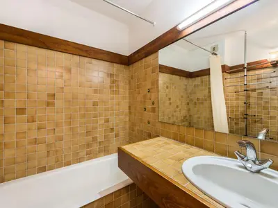 a bathroom with a sink and a mirror and a tub at Appartement 1 Chambre Confort à Megève - Animaux Bienvenus - FR-1-453-61 in Megève