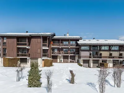 an apartment building with snow in front of it at Appartement 1 Chambre Confort à Megève - Animaux Bienvenus - FR-1-453-61 in Megève