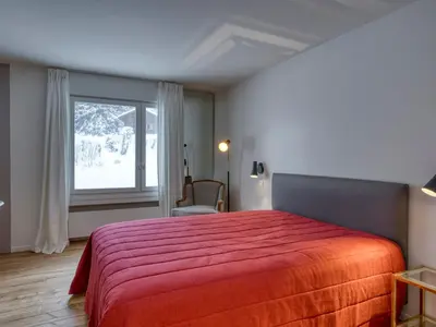 a bedroom with a red bed with a window at Appartement spacieux 1 chambre à Megève, balcon, parking inclus - FR-1-453-62 in Megève