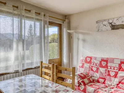a living room with a table and a couch and a window at Appartement cosy 1 chambre à Megève, animaux admis - FR-1-453-63 in Megève