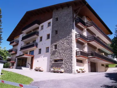 a building with balconies on the side of it at Appartement rénové 2 chambres à Megève Centre avec balcon - FR-1-453-66 in Megève