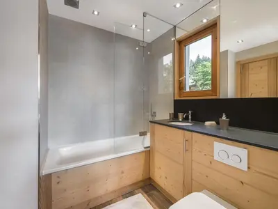 a bathroom with a shower and a toilet and a sink at Appartement rénové 2 chambres à Megève Centre avec balcon - FR-1-453-66 in Megève