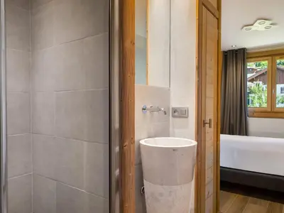 a bathroom with a sink and a bath tub at Appartement rénové 2 chambres à Megève Centre avec balcon - FR-1-453-66 in Megève
