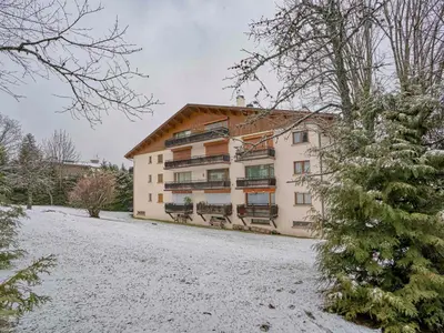 a large building with snow on the ground at Appartement rénové 2 chambres à Megève Centre avec balcon - FR-1-453-66 in Megève