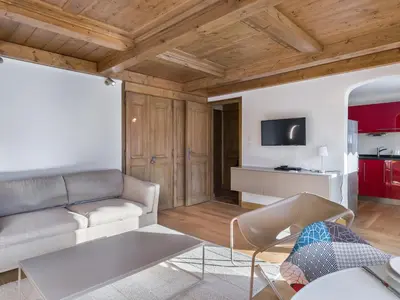 a living room with a couch and a table at Spacieux T2 rénové avec Parking et WiFi à Megève, Proche Pistes - FR-1-453-68 in Megève
