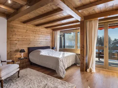 a bedroom with a bed and a large window at Spacieux T2 rénové avec Parking et WiFi à Megève, Proche Pistes - FR-1-453-68 in Megève