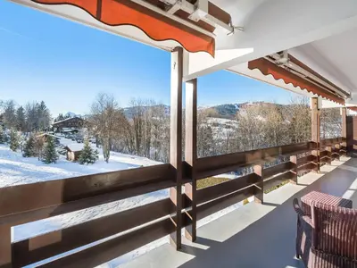 a balcony with a view of the snow covered mountains at Spacieux T2 rénové avec Parking et WiFi à Megève, Proche Pistes - FR-1-453-68 in Megève