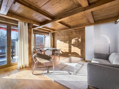 a living room with a couch and a table at Spacieux T2 rénové avec Parking et WiFi à Megève, Proche Pistes - FR-1-453-68 in Megève