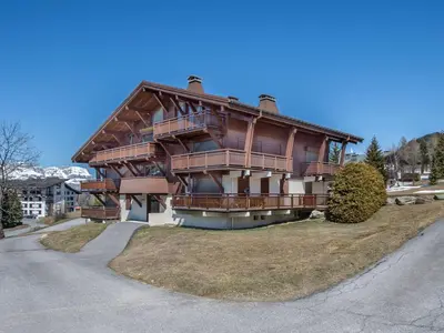 a large wooden house on the side of a road at Appartement 3 pièces, 4 pers, Megève Mont d'Arbois, TV, Wifi - FR-1-453-76 in Megève