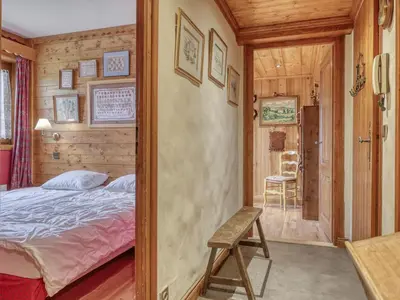 a bedroom with a bed and a chair in a room at Appartement 3 pièces, 4 pers, Megève Mont d'Arbois, TV, Wifi - FR-1-453-76 in Megève