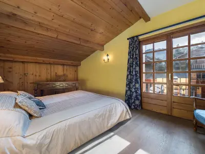 a bedroom with a bed and a large window at Appartement 2 chambres au centre de Megève avec WiFi - FR-1-453-78 in Megève