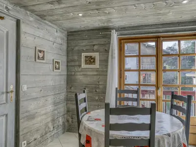 a dining room with a table and chairs and a window at Appartement 2 chambres au centre de Megève avec WiFi - FR-1-453-78 in Megève