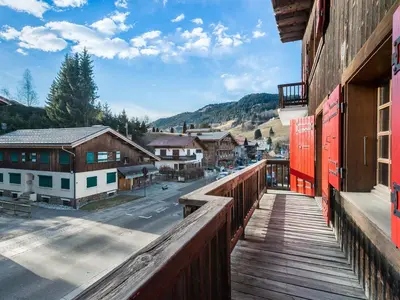 a balcony of a building with a view of a town at Appartement 2 chambres au centre de Megève avec WiFi - FR-1-453-78 in Megève