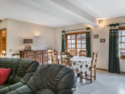 a living room with a couch and a table and chairs at Appartement 2 chambres au centre de Megève avec WiFi - FR-1-453-78 in Megève
