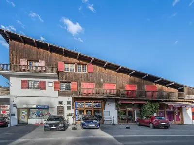 a building with cars parked in front of it at Appartement 2 chambres au centre de Megève avec WiFi - FR-1-453-78 in Megève