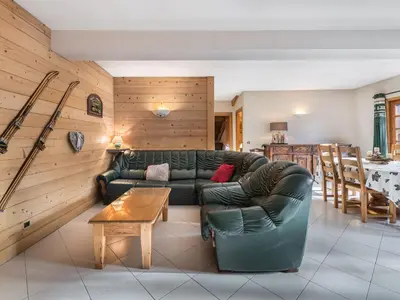 a living room with a green couch and a table at Appartement 2 chambres au centre de Megève avec WiFi - FR-1-453-78 in Megève