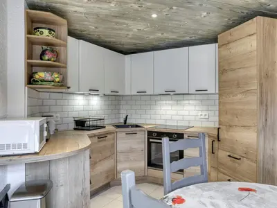 a kitchen with white cabinets and a stove top oven at Appartement 2 chambres au centre de Megève avec WiFi - FR-1-453-78 in Megève