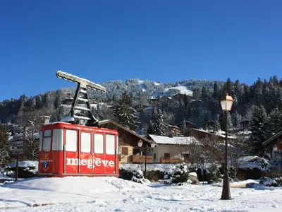 a red train car in the snow next to a street light at Appartement 3 pièces avec balcon et wifi - Megeve Jaillet - FR-1-453-80 in Megève