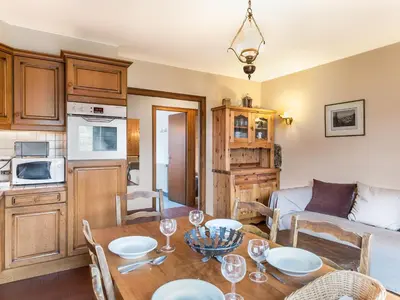 a kitchen and living room with a table and chairs at Appartement 3 pièces avec balcon et wifi - Megeve Jaillet - FR-1-453-80 in Megève