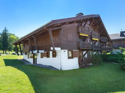 a large wooden building with balconies and a yard at Charmant 2 pièces proche pistes à Megève - FR-1-453-83 in Megève