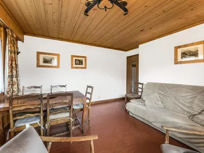 a living room with a table and a couch at Appartement 2 pièces au rez-de-chaussée - Animaux admis - Près des pistes - FR-1-453-91 in Megève