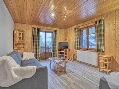 a living room with a couch and a tv at Appartement confortable à Megève - Centre, 50m², 4 personnes, 3 balcons, TV et Wifi - FR-1-453-92 in Megève
