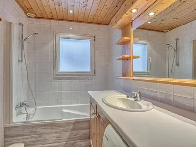 a bathroom with a sink and a bath tub and a mirror at Appartement confortable à Megève - Centre, 50m², 4 personnes, 3 balcons, TV et Wifi - FR-1-453-92 in Megève