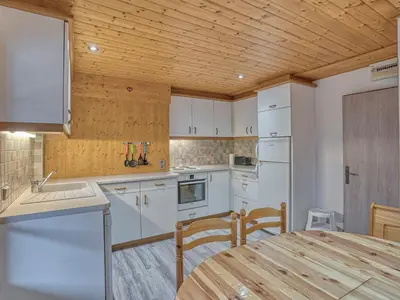 a kitchen with white appliances and a wooden ceiling at Appartement confortable à Megève - Centre, 50m², 4 personnes, 3 balcons, TV et Wifi - FR-1-453-92 in Megève