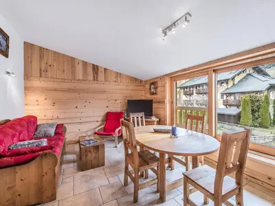 a living room with a table and a couch at Charmant 3 pièces au centre de Megève, idéal 4 pers - FR-1-453-96 in Megève