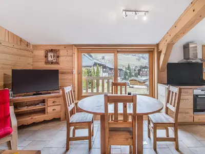 a kitchen and dining room with a table and chairs at Charmant 3 pièces au centre de Megève, idéal 4 pers - FR-1-453-96 in Megève