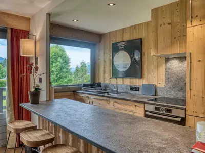 a kitchen with a large counter and a large window at Confortable Appartement 3 Chambres au Centre de Megève avec Wifi - FR-1-453-100 in Megève
