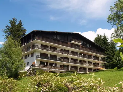 a large building with balconies on a hill at Confortable Appartement 3 Chambres au Centre de Megève avec Wifi - FR-1-453-100 in Megève